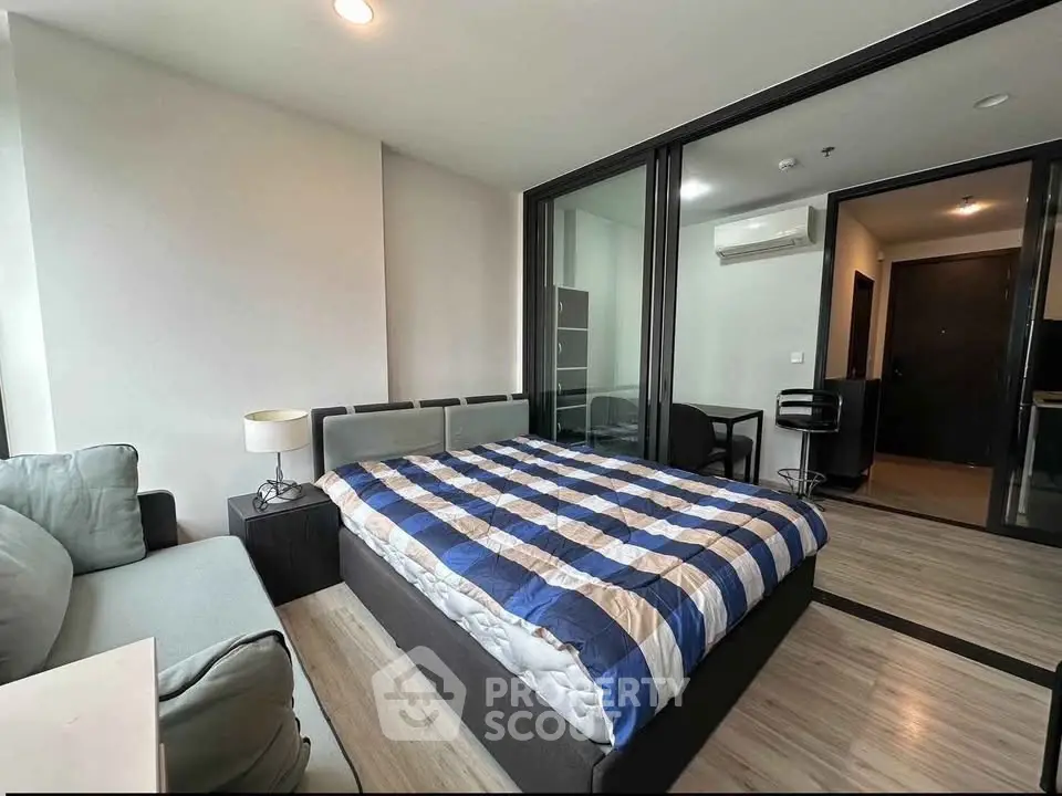 Modern bedroom with cozy bed and stylish decor in a contemporary apartment.