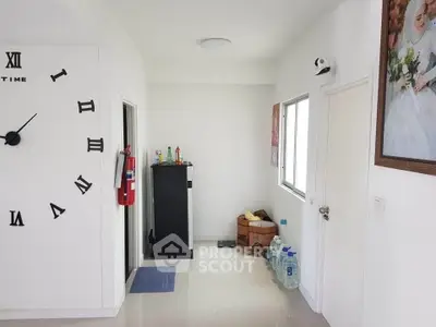Modern hallway with wall clock and minimal decor