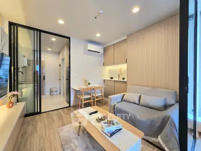 Modern living room with cozy sofa, stylish decor, and open layout in contemporary apartment.