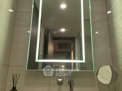 Modern bathroom with illuminated mirror and sleek fixtures