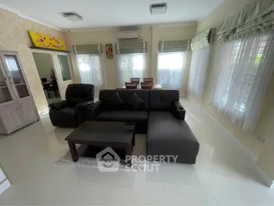 Spacious living room with modern furniture and large windows for natural light.