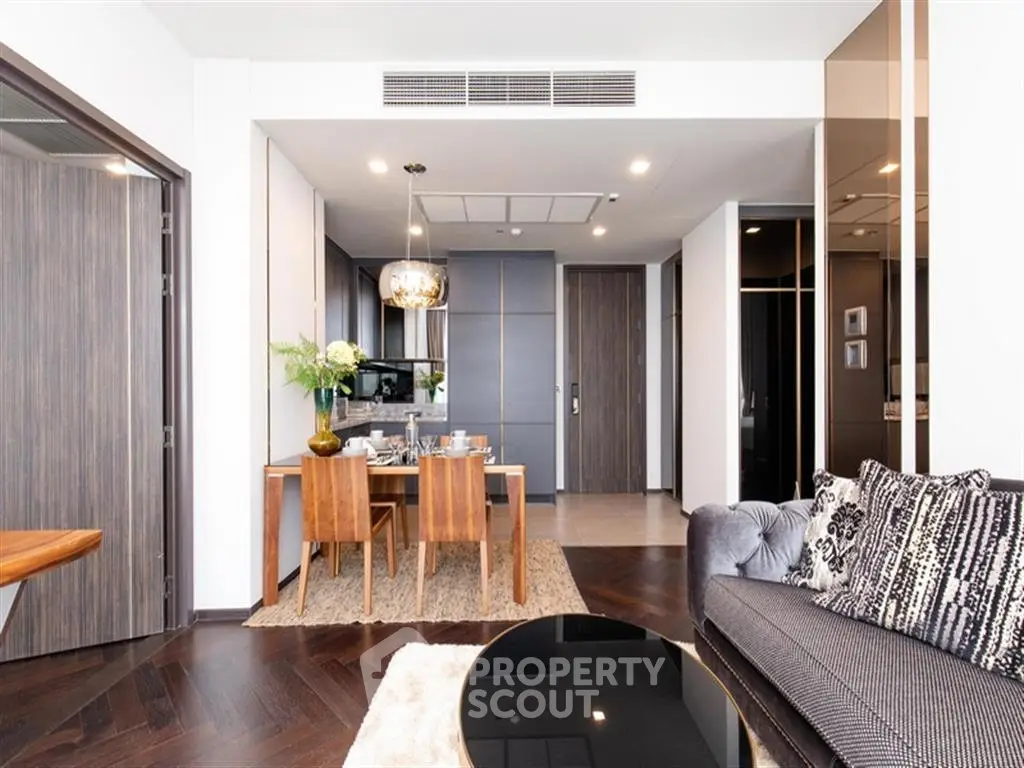 Modern open-plan living and dining area with stylish decor and hardwood floors in a luxury apartment.