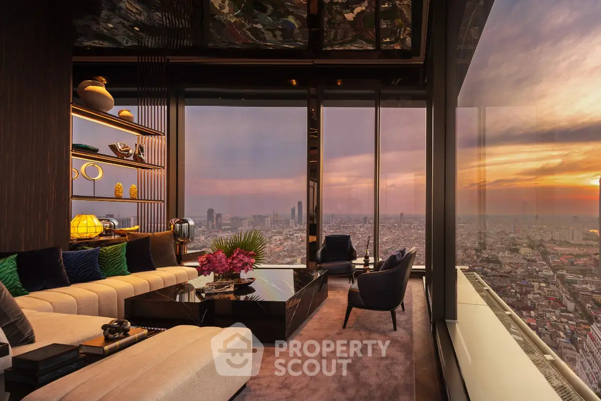 Luxurious high-rise living room with panoramic city views and elegant decor at sunset.