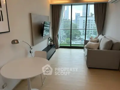Modern living room with city view, featuring sleek furniture and large windows for natural light.