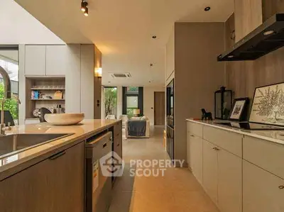Modern open-layout kitchen with sleek cabinetry and spacious living area view.