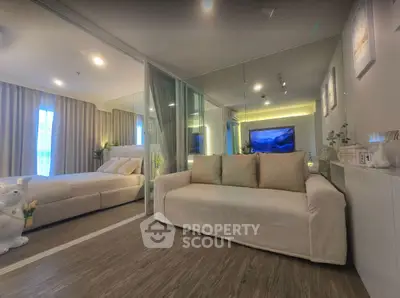 Modern living room with cozy sofa and stylish decor in open-plan apartment