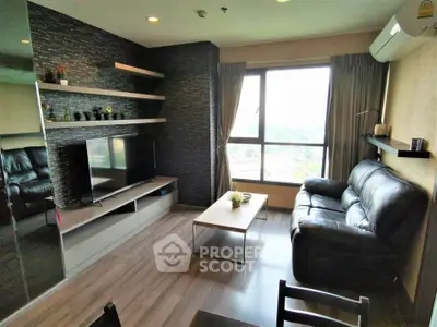 Modern living room with sleek design, large window, and comfortable seating in a high-rise apartment.