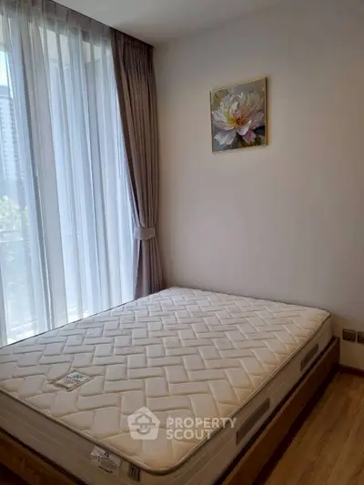 Bright bedroom with large window and modern decor