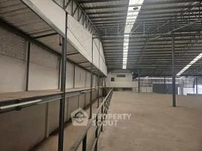 Spacious industrial warehouse with high ceilings and ample storage space.