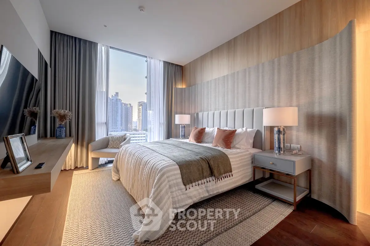 Luxurious modern bedroom with city view, elegant decor, and cozy ambiance.