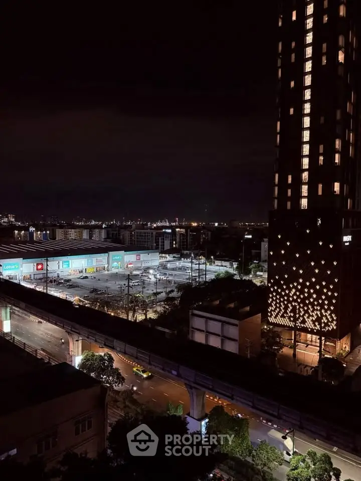 Stunning night view of urban landscape with illuminated buildings and city lights.