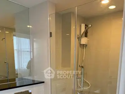 Modern bathroom with glass shower enclosure and sleek fixtures