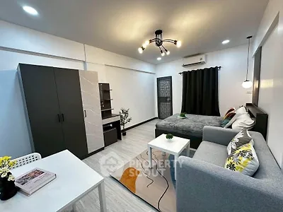 Modern studio apartment with stylish decor and cozy living area, perfect for urban living.