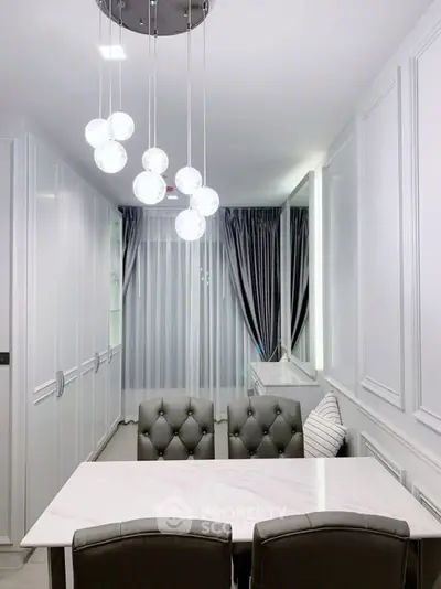 Elegant dining area with modern lighting and luxurious curtains