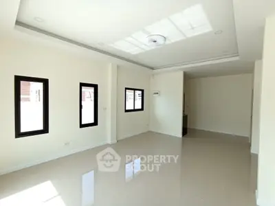 Spacious and bright living room with modern ceiling design and large windows