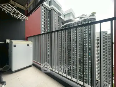 Modern high-rise balcony with cityscape view and washing machine