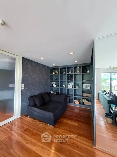 Stylish living room with modern decor and built-in shelving in a contemporary apartment.