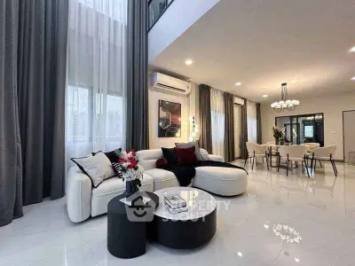 Luxurious modern living room with elegant decor and open dining area, featuring high ceilings and chic furnishings.