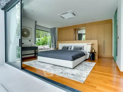 Luxurious modern bedroom with large windows and garden view, featuring elegant decor and spacious layout.
