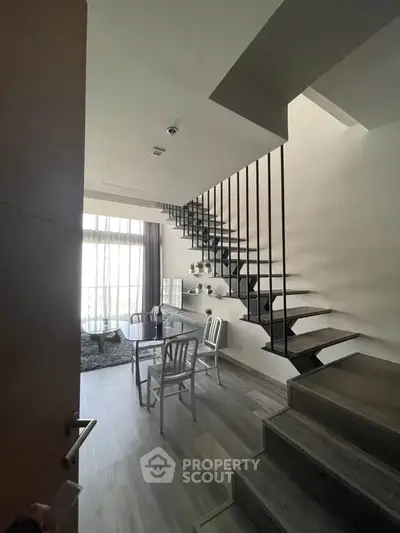 Modern duplex interior with stylish staircase and cozy dining area