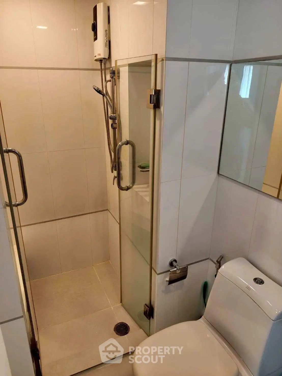 Compact bathroom with shower and modern fixtures in a sleek design