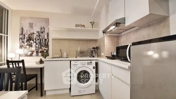 Modern kitchen with washing machine and sleek white cabinetry