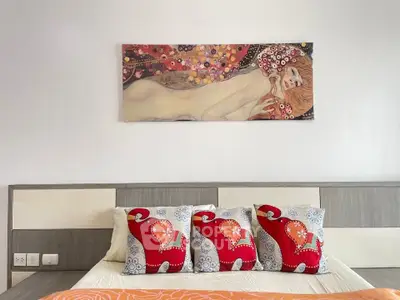 Stylish bedroom with modern art and vibrant cushions