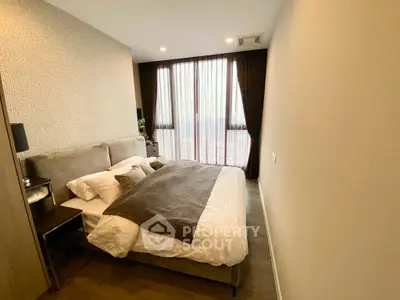 Cozy modern bedroom with large window and stylish decor