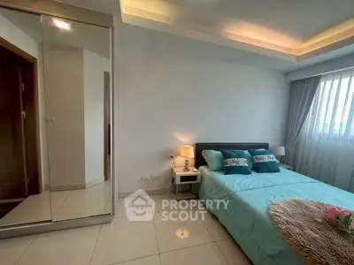 Modern bedroom with elegant decor and large mirror wardrobe in a bright apartment.