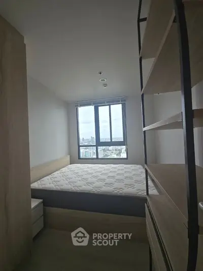 Cozy bedroom with large window offering stunning city view