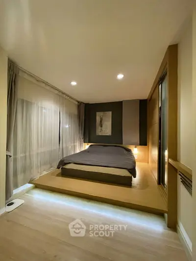 Modern minimalist bedroom with platform bed and ambient lighting