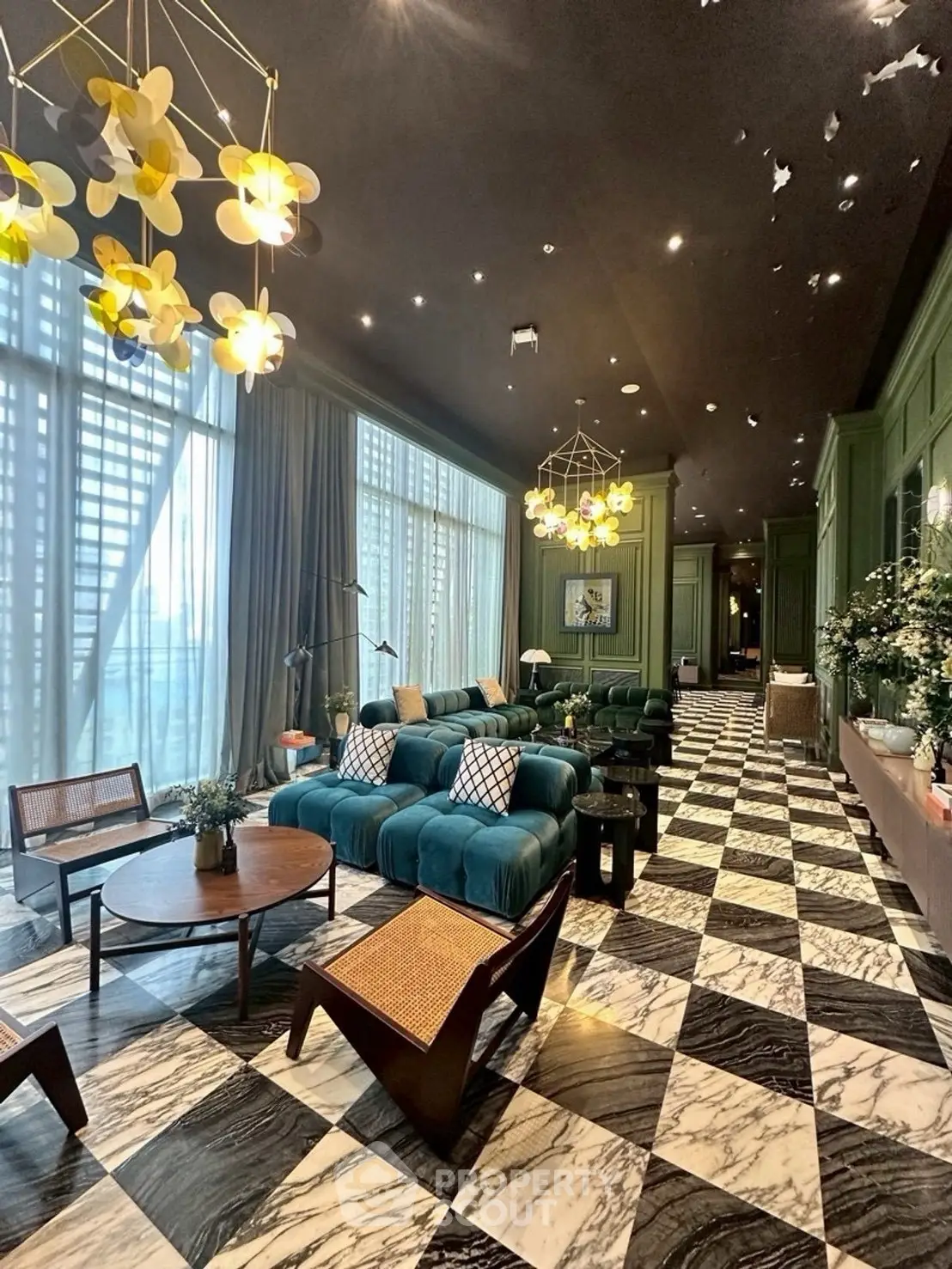 Luxurious living room with elegant decor and large windows, featuring stylish furniture and unique lighting.