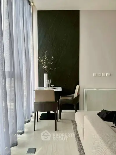 Modern living room with elegant dining area and floor-to-ceiling windows