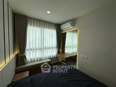 Modern bedroom with large window, stylish curtains, and sleek air conditioning unit.
