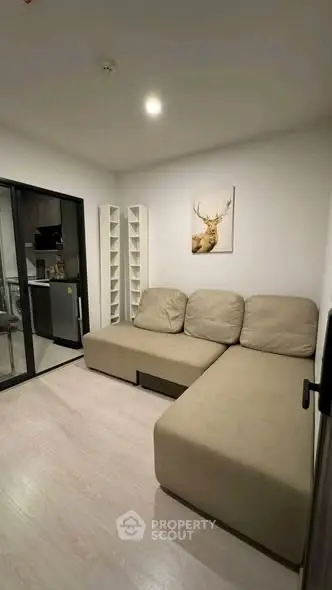 Modern living room with beige sectional sofa and minimalist decor