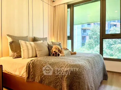 Luxurious bedroom with plush bedding and large windows offering a serene view, perfect for relaxation.