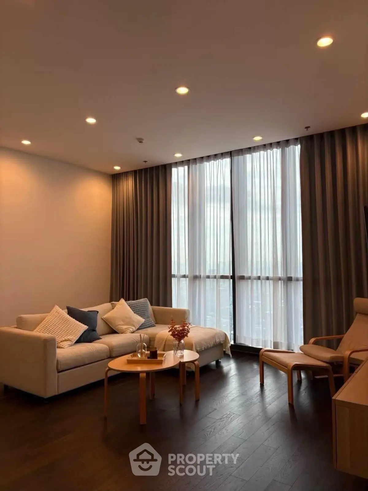 Elegant living room with modern furniture and floor-to-ceiling windows