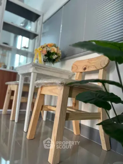 Modern interior with wooden chairs and floral arrangement, perfect for cozy living spaces.