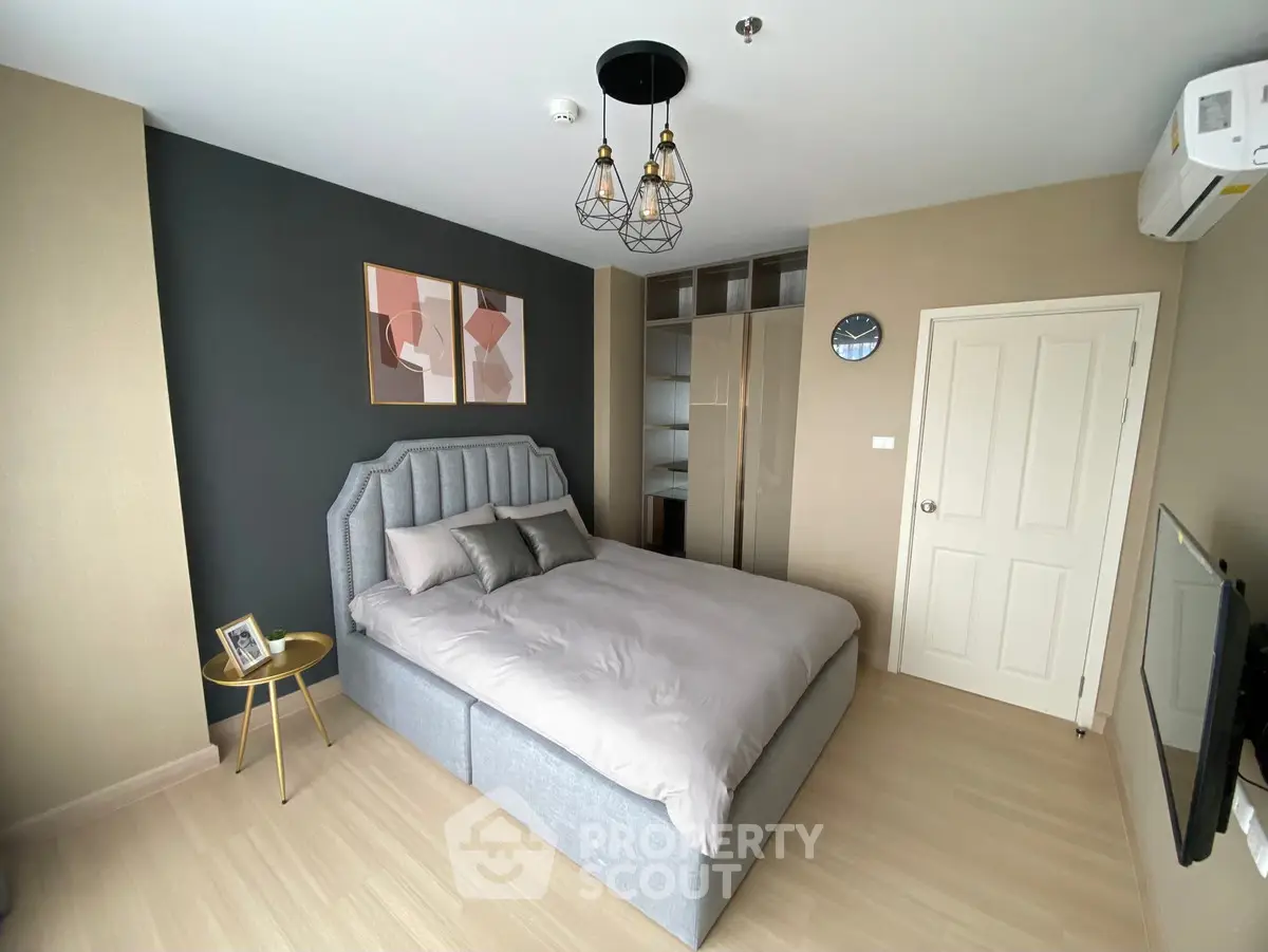 Modern bedroom with stylish decor and ample natural light