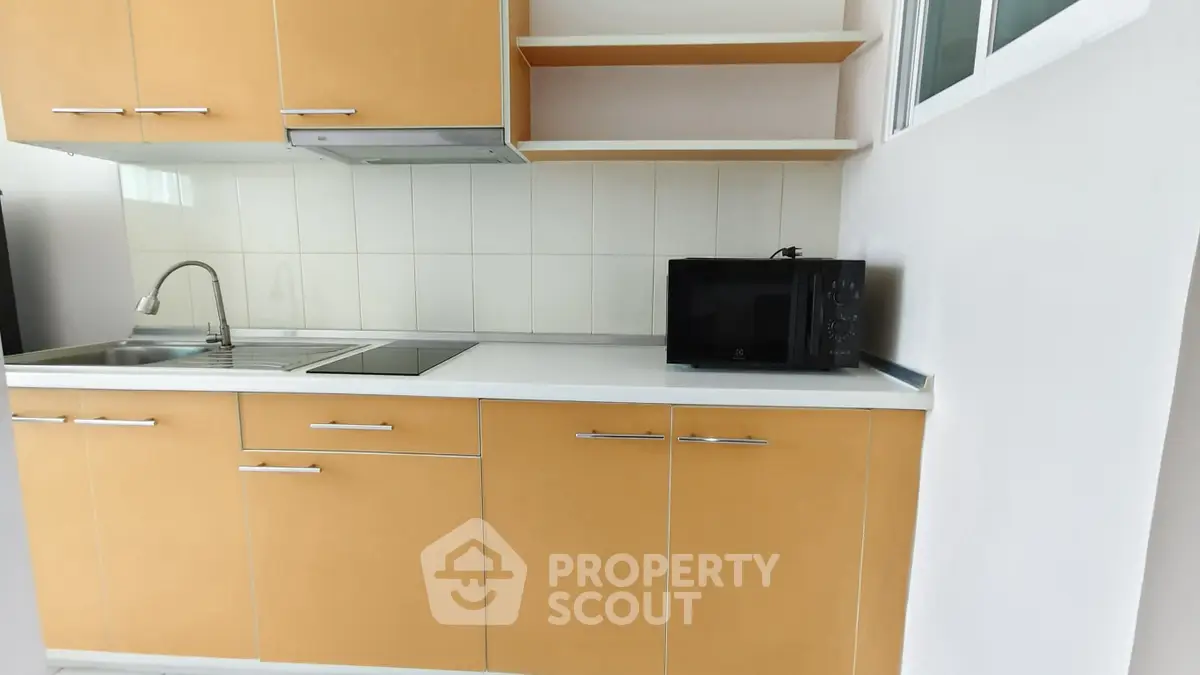 Modern kitchen with sleek cabinetry and built-in appliances, perfect for urban living.
