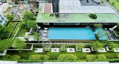 Luxurious rooftop pool with lush garden view in modern residential complex