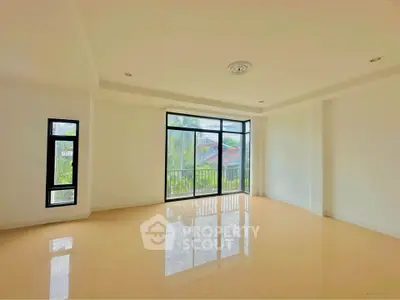 Spacious empty living room with large windows and natural light