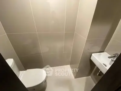 Modern minimalist bathroom with sleek fixtures and neutral tiles
