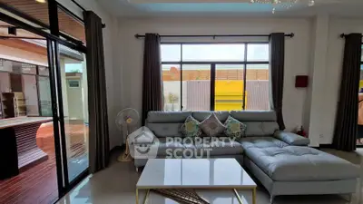 Spacious living room with modern decor and large windows for natural light