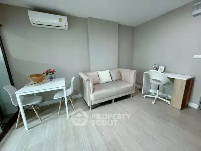 Modern living room with stylish furniture and air conditioning, perfect for comfortable living.