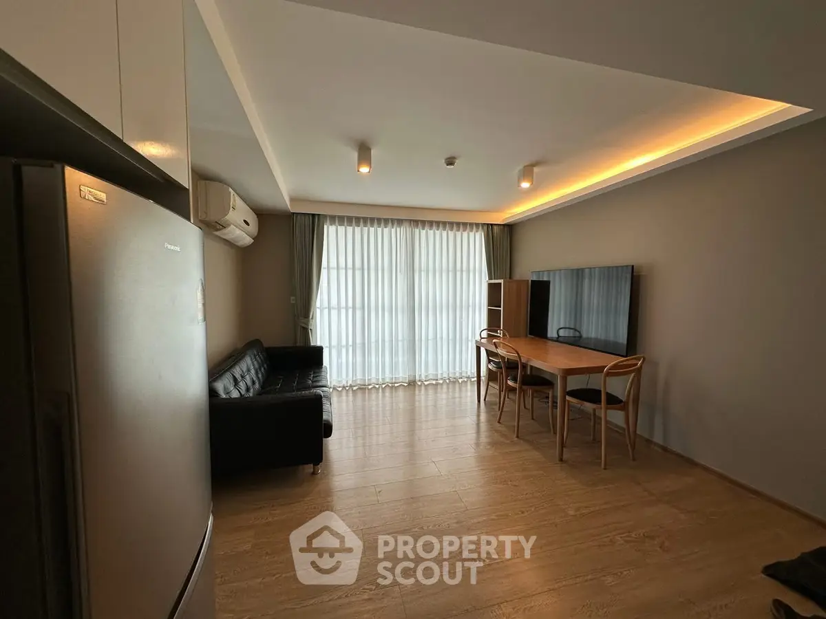 Modern living room with sleek furniture and ambient lighting in a stylish apartment.