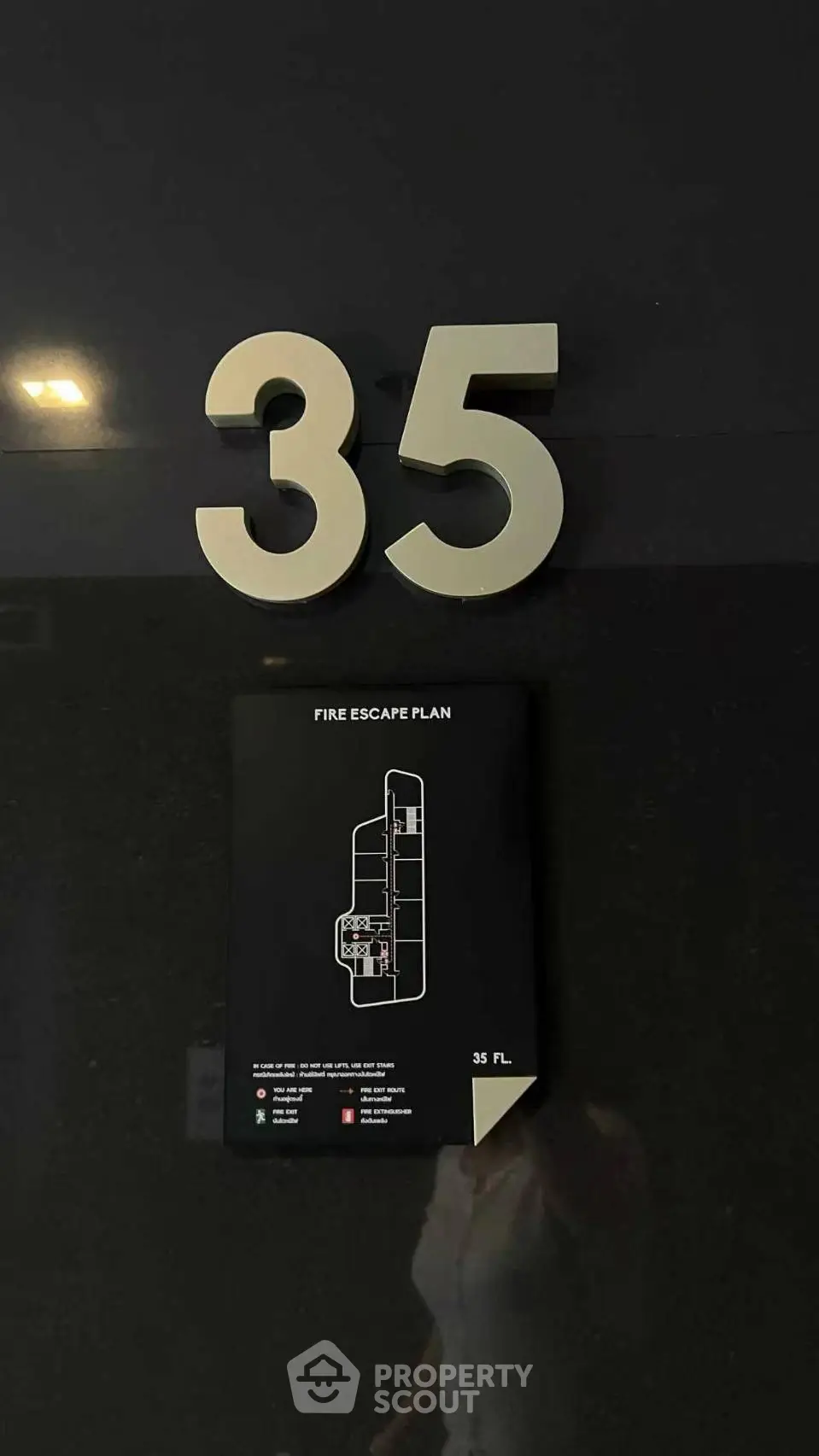 Modern building floor number with fire escape plan on wall