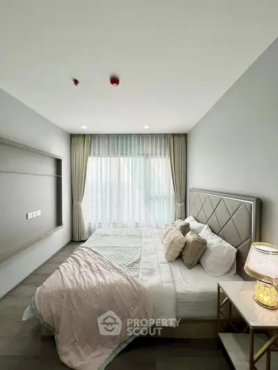 Spacious modern bedroom with elegant decor and natural light