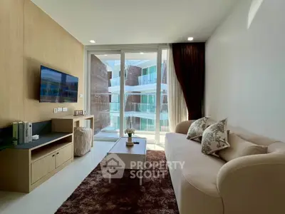 Modern living room with cozy sofa and large window offering natural light and balcony view.