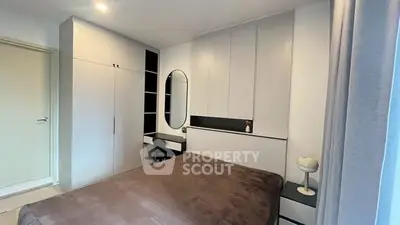 Modern bedroom with sleek built-in wardrobe and cozy decor